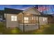 Charming back porch offers a cozy retreat for relaxation, featuring views of the green lawn and wooded surroundings at 125 Leisure Ln, Louisburg, NC 27549