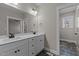 Bathroom featuring double sinks, white cabinets, modern faucets, and stylish tile flooring at 125 Leisure Ln, Louisburg, NC 27549