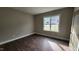 Simple bedroom with hardwood floors and a window at 125 Leisure Ln, Louisburg, NC 27549