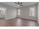 Spacious bedroom boasts wood floors, two windows, and ensuite bathroom at 125 Leisure Ln, Louisburg, NC 27549