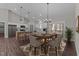 Bright dining area featuring a wooden table, stylish chairs, and a modern chandelier, adjacent to the kitchen at 125 Leisure Ln, Louisburg, NC 27549