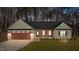 Charming single-story home featuring stone accents, a two-car garage, and inviting curb appeal at 125 Leisure Ln, Louisburg, NC 27549