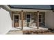 Inviting front porch featuring stone detail, natural wood posts, craftsman front door, and a house number at 125 Leisure Ln, Louisburg, NC 27549