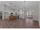 Open-concept kitchen with stainless appliances, white cabinets, island, and seamless flow to the living space at 125 Leisure Ln, Louisburg, NC 27549