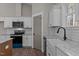 Modern kitchen featuring stainless steel appliances, white cabinetry, and subway tile backsplash at 125 Leisure Ln, Louisburg, NC 27549