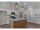 Well-lit kitchen with white cabinets, stainless steel appliances, and a center island with a marble countertop at 125 Leisure Ln, Louisburg, NC 27549