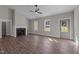 Spacious living room with a fireplace, large windows, and neutral tones, offering a comfortable living space at 125 Leisure Ln, Louisburg, NC 27549