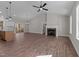 Open-concept living room with a fireplace, hardwood floors, and seamless transition to the adjacent kitchen area at 125 Leisure Ln, Louisburg, NC 27549