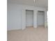 Carpeted bedroom with a double-door closet providing ample storage at 130 S Estes Dr # G5, Chapel Hill, NC 27514