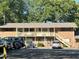 Apartment building showcasing a brick facade, balconies and parking spaces, reflecting a well-maintained living space at 130 S Estes Dr # G5, Chapel Hill, NC 27514