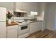 Bright kitchen featuring white appliances, white cabinets, and a modern sink at 130 S Estes Dr # G5, Chapel Hill, NC 27514