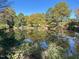 Scenic view of the community pond reflecting the surrounding trees at 130 S Estes Dr # G5, Chapel Hill, NC 27514
