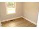 Simple bedroom with wood-look floors and a window offering natural light at 2253 Nc Highway 96 S, Franklinton, NC 27525
