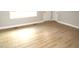 An empty bedroom features sleek wood flooring, white trim, and two white doors at 2253 Nc Highway 96 S, Franklinton, NC 27525