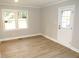 Bedroom with a large window, wood flooring, and a door to the exterior at 2253 Nc Highway 96 S, Franklinton, NC 27525