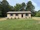 Classic one-story home with a brick front, dark shutters, and lush green lawn, offering a welcoming curb appeal at 2253 Nc Highway 96 S, Franklinton, NC 27525