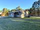 Side view of a ranch house with gray siding, showcasing the backyard at 2253 Nc Highway 96 S, Franklinton, NC 27525
