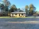 Front view of a ranch house with a lawn and mature trees at 2253 Nc Highway 96 S, Franklinton, NC 27525