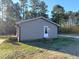 Rear view of a ranch house with a white door and gray siding at 2253 Nc Highway 96 S, Franklinton, NC 27525