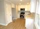 Modern kitchen with white cabinets, stainless steel appliances, and quartz countertops at 2253 Nc Highway 96 S, Franklinton, NC 27525