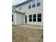 Neutral-colored two-story house with a concrete patio and newly installed sod in the backyard at 226 Begen St, Morrisville, NC 27560