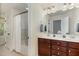 Well-lit bathroom with dual vanities, a shower-tub combo, and modern fixtures at 226 Begen St, Morrisville, NC 27560