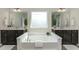Elegant bathroom with a large soaking tub, dual vanities, and a bright window at 226 Begen St, Morrisville, NC 27560