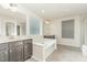 Bright bathroom with soaking tub, walk-in shower, and double vanities at 226 Begen St, Morrisville, NC 27560