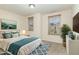 Bright bedroom with a bed, dresser, and large window at 226 Begen St, Morrisville, NC 27560