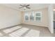 A large bright bedroom featuring a trey ceiling, ceiling fan and large windows at 226 Begen St, Morrisville, NC 27560