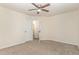 Clean bedroom space with carpet, ceiling fan, and a hallway entrance at 226 Begen St, Morrisville, NC 27560