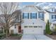 Charming two-story home featuring a red door, stone accents, and a two-car garage at 226 Begen St, Morrisville, NC 27560