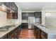 Eat-in kitchen with dark cabinetry, granite countertops, and stainless steel appliances at 226 Begen St, Morrisville, NC 27560