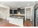 Spacious kitchen with dark cabinetry, granite countertops, and stainless steel appliances at 226 Begen St, Morrisville, NC 27560