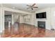 Open-concept living room with hardwood floors, fireplace, and seamless access to kitchen at 226 Begen St, Morrisville, NC 27560