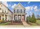 Charming two-story home featuring a welcoming red front door, cozy front porch, and manicured landscaping at 283 Daniel Ridge Rd, Wendell, NC 27591