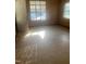 Sunlit room showcasing a door, large windows, and vintage flooring at 420 E Hinton St, Clayton, NC 27520