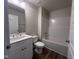 Modern bathroom features a vanity with sink, toilet, and a shower-tub combination at 4553 Dedication Dr, Raleigh, NC 27610