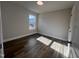 Bedroom featuring wood-look flooring, neutral walls and a bright window at 4553 Dedication Dr, Raleigh, NC 27610