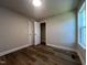 Bedroom featuring wood-look floors, neutral walls, closet and a window at 4553 Dedication Dr, Raleigh, NC 27610