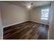 Cozy bedroom with wood floors, neutral walls, and a window providing natural light at 4553 Dedication Dr, Raleigh, NC 27610