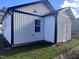 Exterior side view of a bright white siding home featuring black trim and a lush green yard at 4553 Dedication Dr, Raleigh, NC 27610