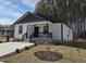 Charming single-story home featuring white siding, black trim, and a cozy front porch at 4553 Dedication Dr, Raleigh, NC 27610