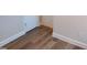Hallway featuring durable wood-look floors, white baseboards, and door frames at 4553 Dedication Dr, Raleigh, NC 27610
