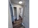 Hallway features wood-look floors with a view into closet and bathroom at 4553 Dedication Dr, Raleigh, NC 27610
