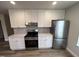 Modern kitchen featuring white cabinets, stainless steel appliances, and elegant countertops at 4553 Dedication Dr, Raleigh, NC 27610