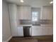 Well-lit kitchen with ample storage, sleek stainless steel dishwasher, and modern finishes at 4553 Dedication Dr, Raleigh, NC 27610