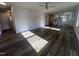 Open-concept living room with wood floors, ceiling fan, flowing into the kitchen area at 4553 Dedication Dr, Raleigh, NC 27610
