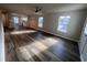 Bright living room featuring wood flooring, neutral walls, and large windows for natural light at 4553 Dedication Dr, Raleigh, NC 27610