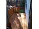 Wooden porch with railings leading to the home's entrance, offering outdoor space with natural light at 4553 Dedication Dr, Raleigh, NC 27610